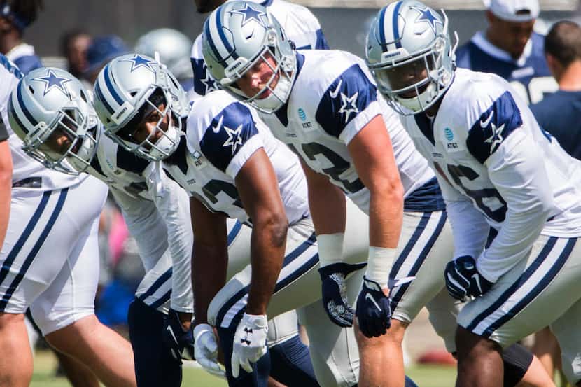 Dallas Cowboys offensive backs line up to run during a morning practice at training camp in...