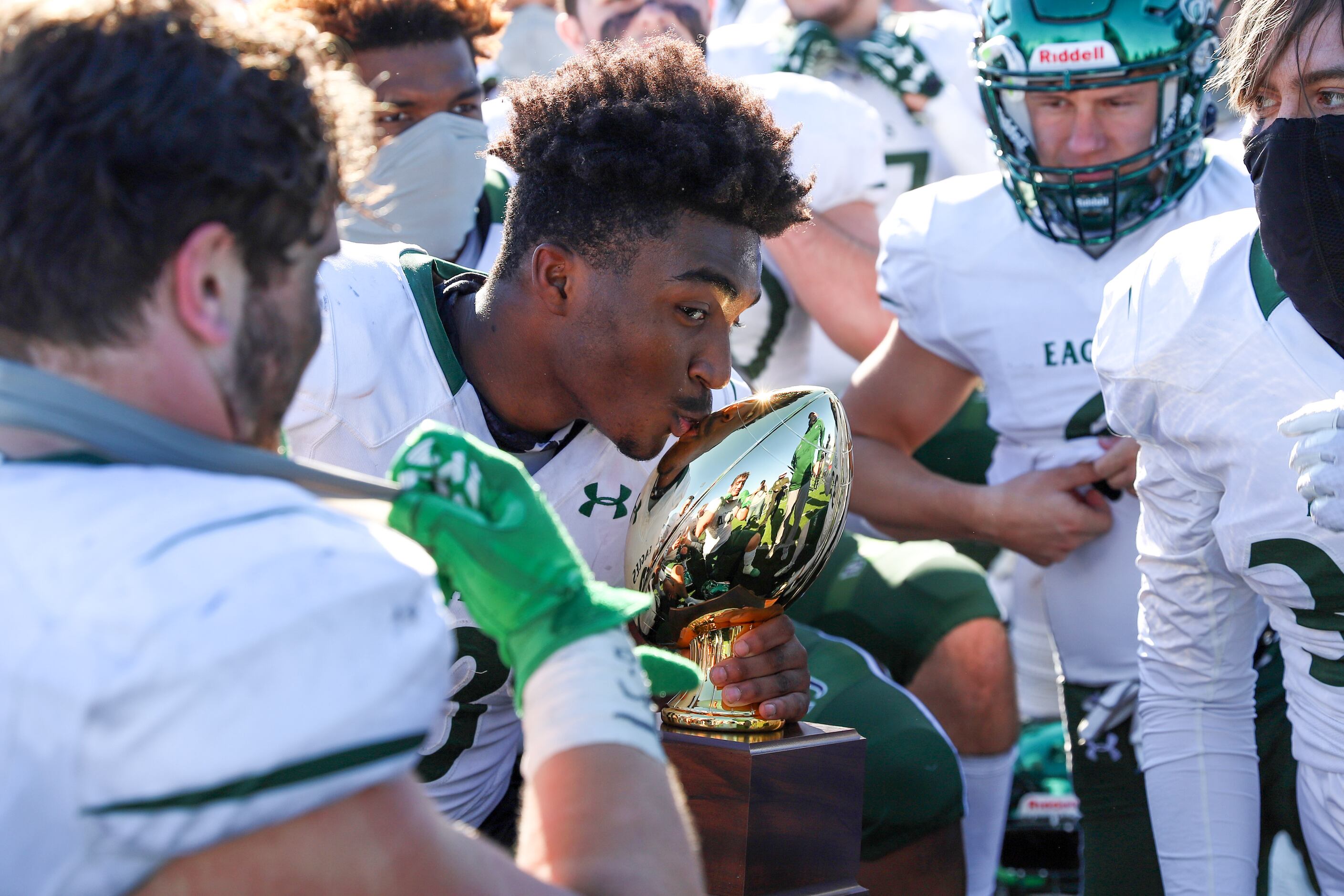 Prosper’s Tyler Bailey (8) kisses the trophy after a bi-district playoff win against Flower...