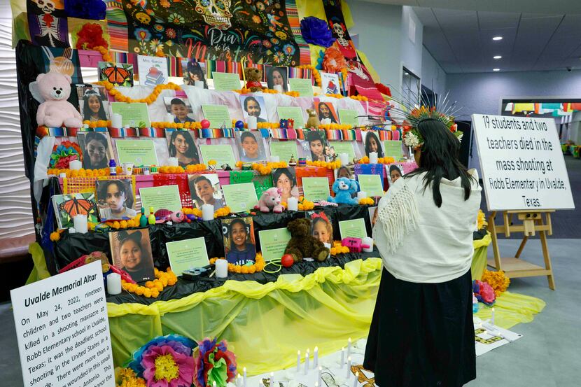 Sandra Avalos, 33, stands at a Uvalde Memorial altar during Marcha de los Niños at Dallas...