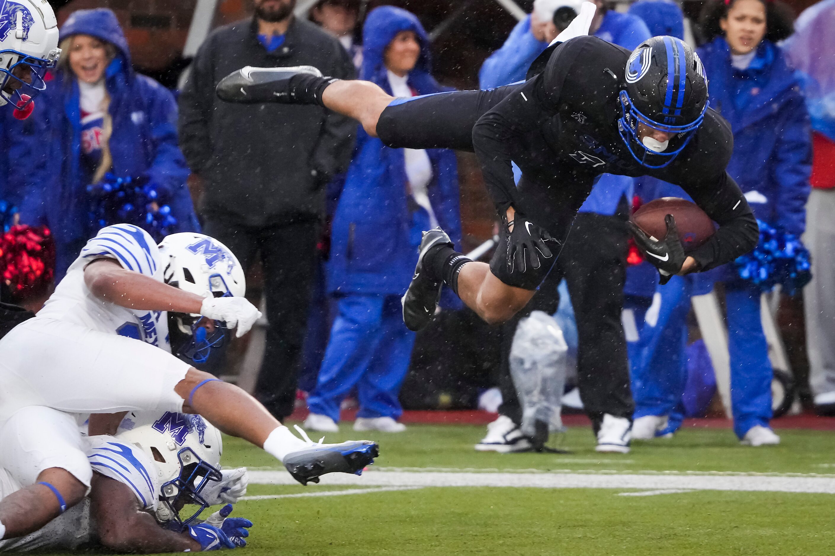 SMU wide receiver Jordan Kerley (1) is knocked off his feet by the Memphis defense after a...