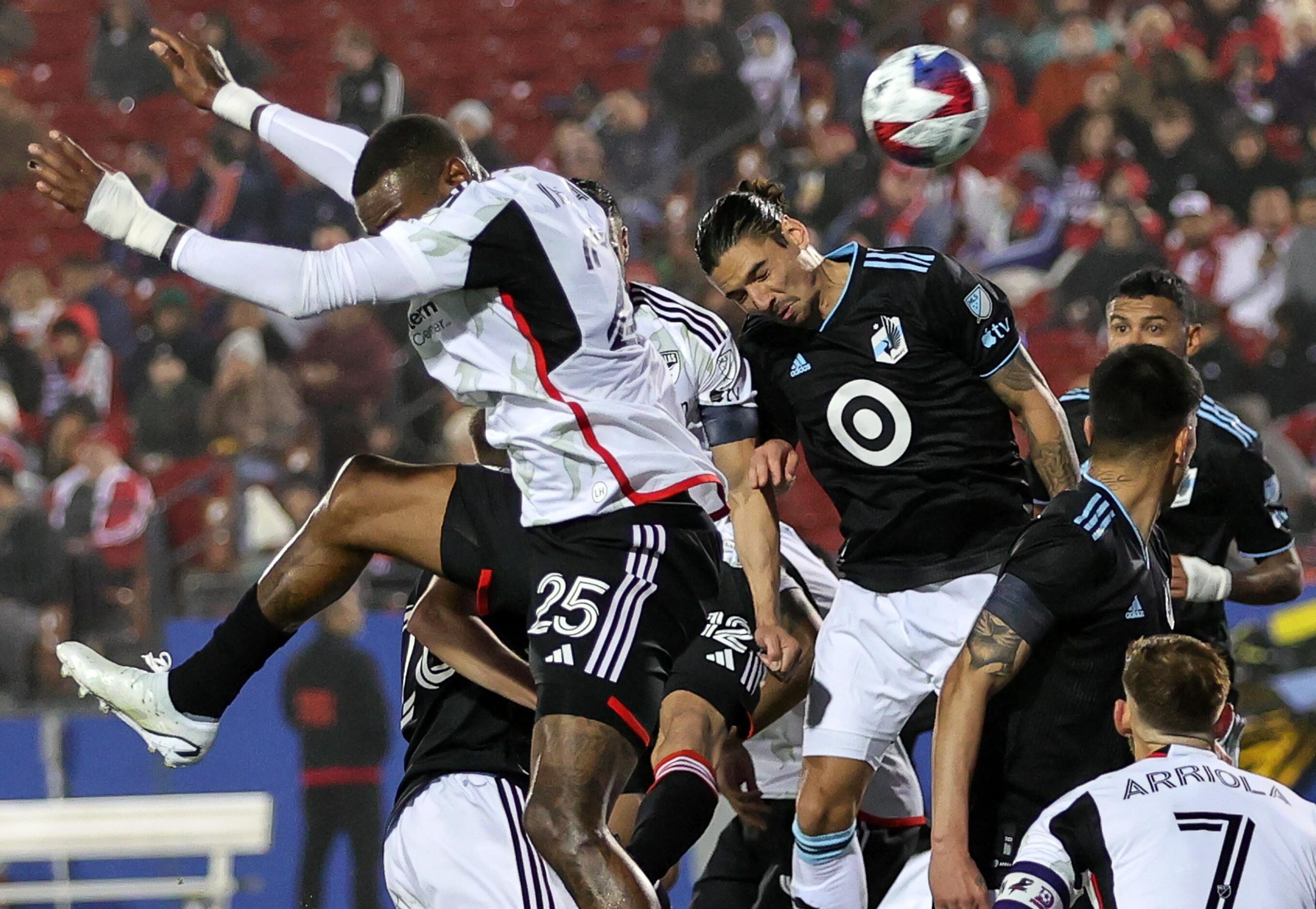 Minnesota United defender Zarek Valentin, (right) heads the ball against FC Dallas defender...