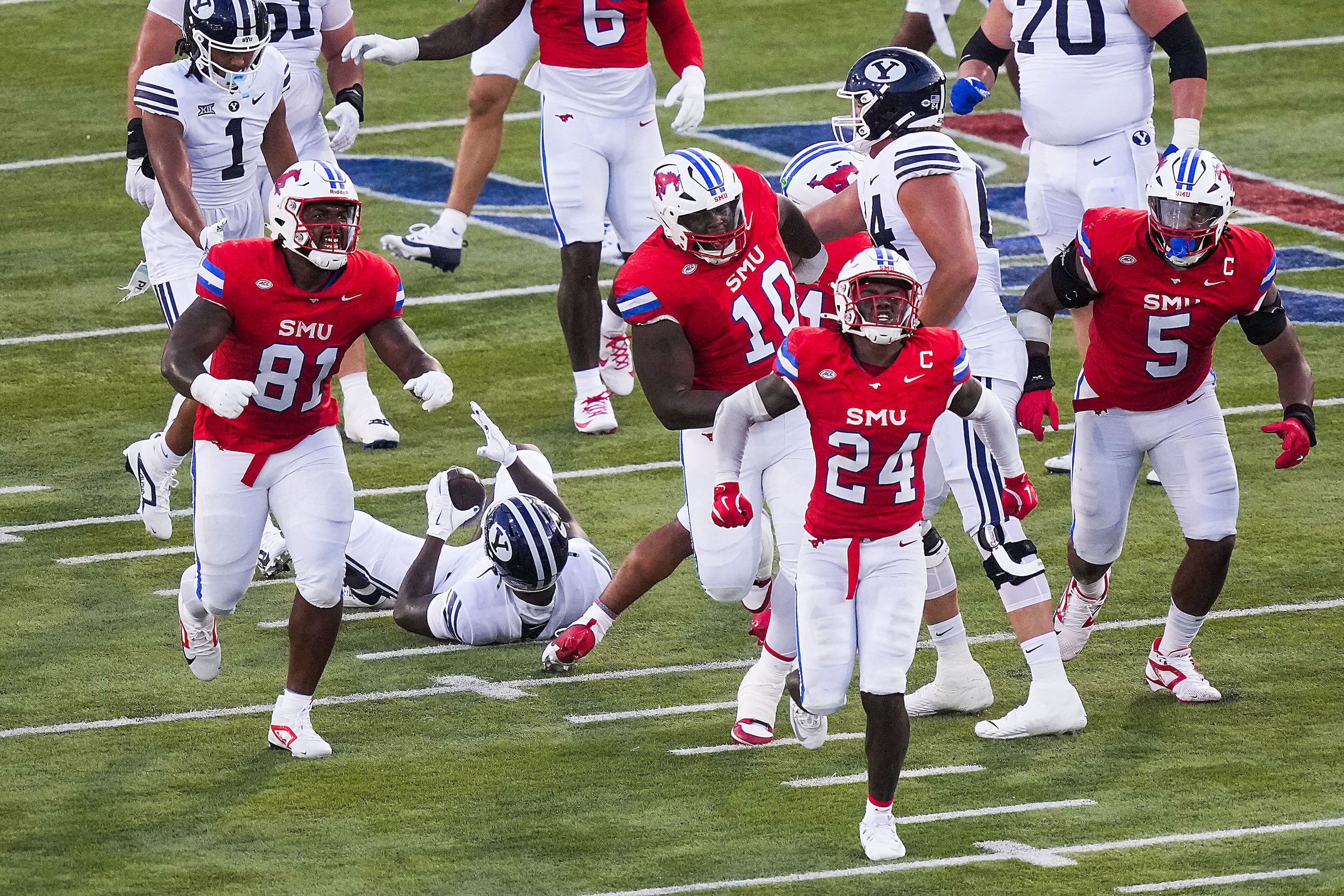 SMU linebacker Kobe Wilson (24) celebrates after stopping BYU running back Miles Davis (4)...