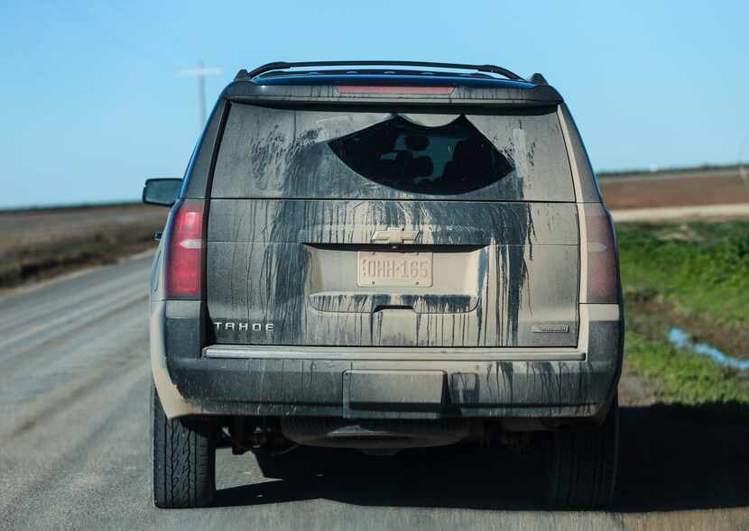 Dust cakes the back of Sharon Wilson and Alan Septoff's  black rental SUV as they ply...