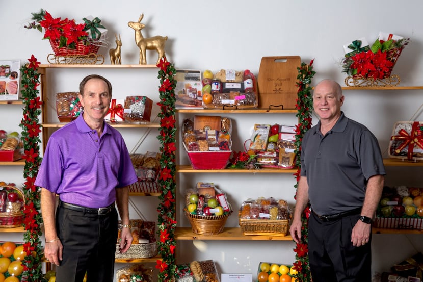 Chuck (left) and Bobby Goodman, co-owners of Goodies From Goodman, are hanging up their...