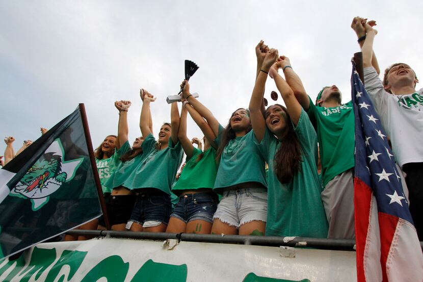 Southlake Carroll fans filling the student section voice their support of their team during...