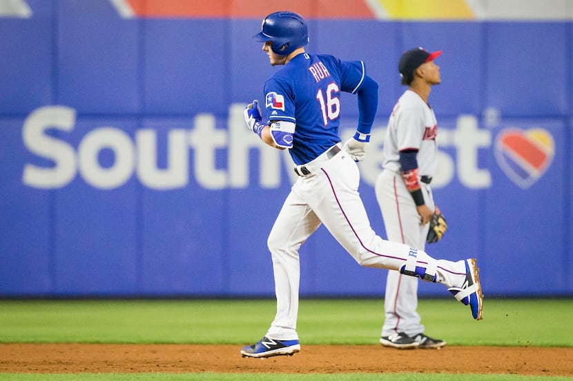 Texas Rangers first baseman Ryan Rua rounds the bases after hitting a grand slam off of...