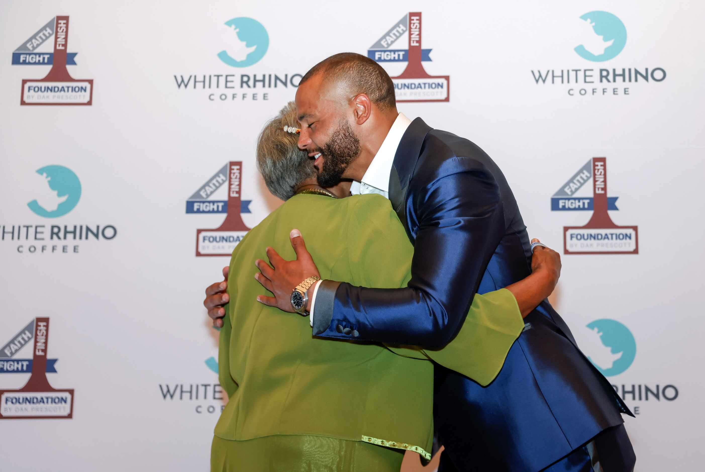 Founder and Dallas Cowboys quarterback Dak Prescott embraces family and friends at the...