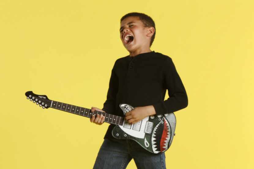 Jonathan McSween, 7, in character as a rock star for Parent's Guide to Summer, photographed...