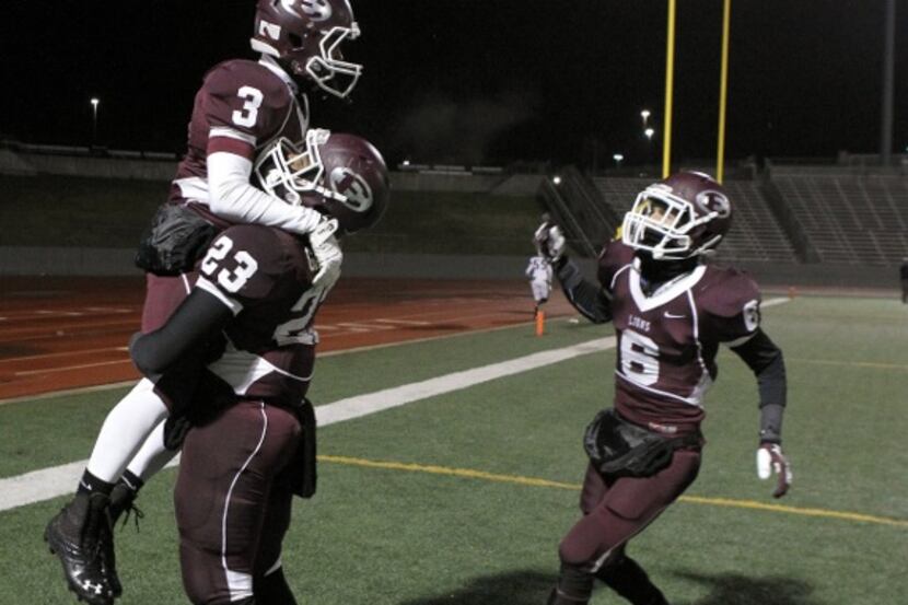 Ennis Lions CB Taylor Thompson (3) is lifted by Ennis Lions' Nick Gabriele (23) after...