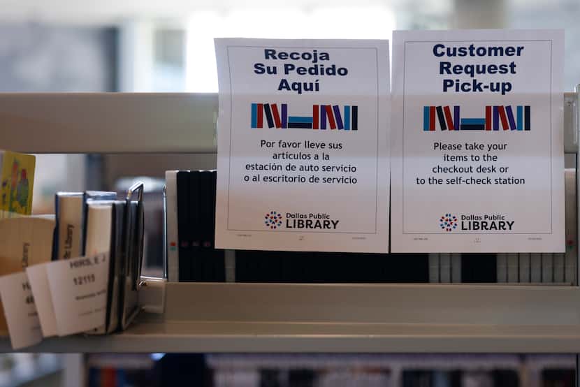Signs containing information in English and Spanish in Vickery Meadow Library on  Friday,...