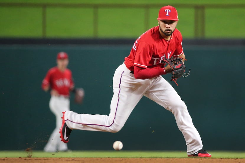 Texas second baseman Isiah Kiner-Falefa fields a grounder in the ninth inning during the Los...