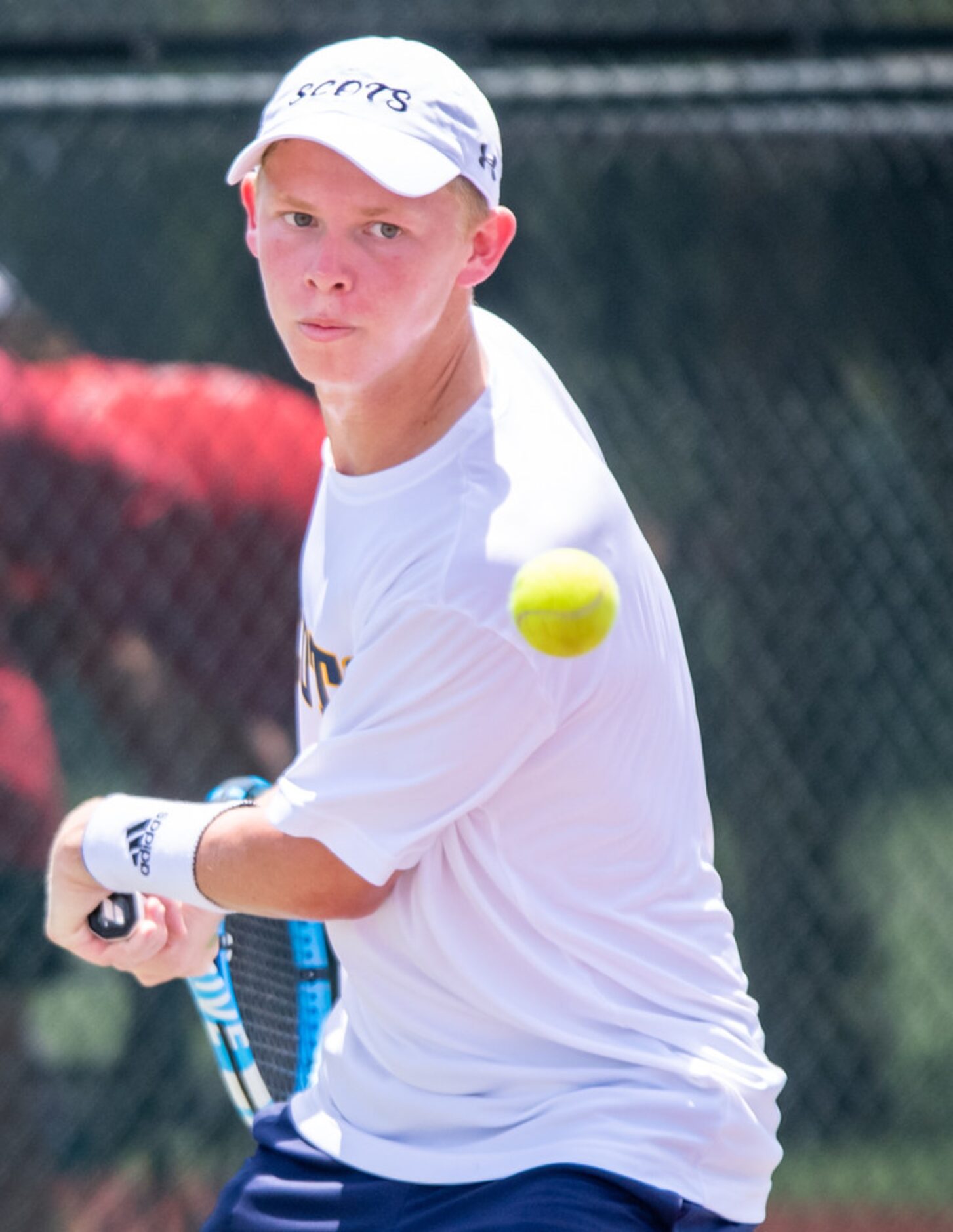 Highland Park's Rhett Bailey returns the ball in a doubles match with teammate Ashlee Newton...