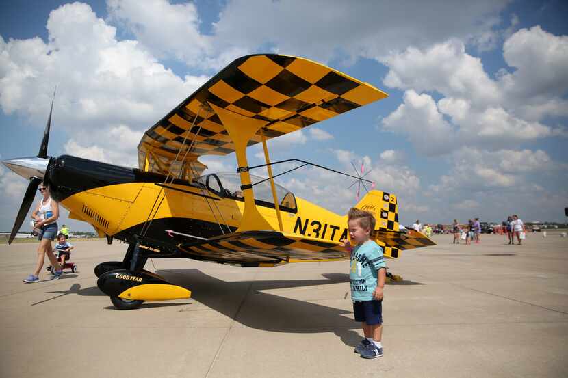 London Stefanescu, 2, stands near a plane on display during the Flights of Our Fathers Air...