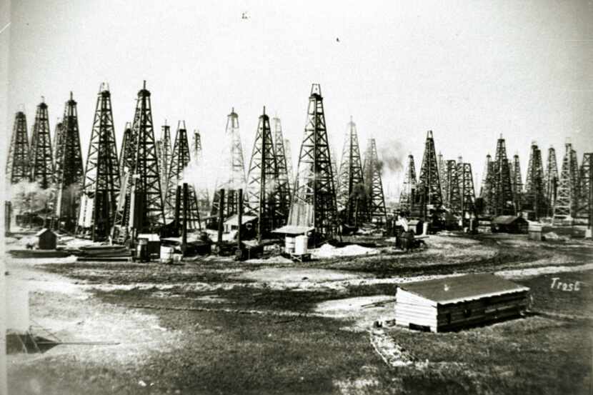 Derricks pump oil at the Spindletop oil field near Beaumont. The first gusher hit there...