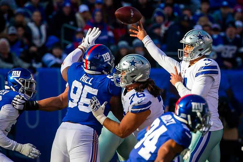 Cowboys quarterback Dak Prescott (4) attempts a pass while offensive guard Xavier Su'a-Filo...