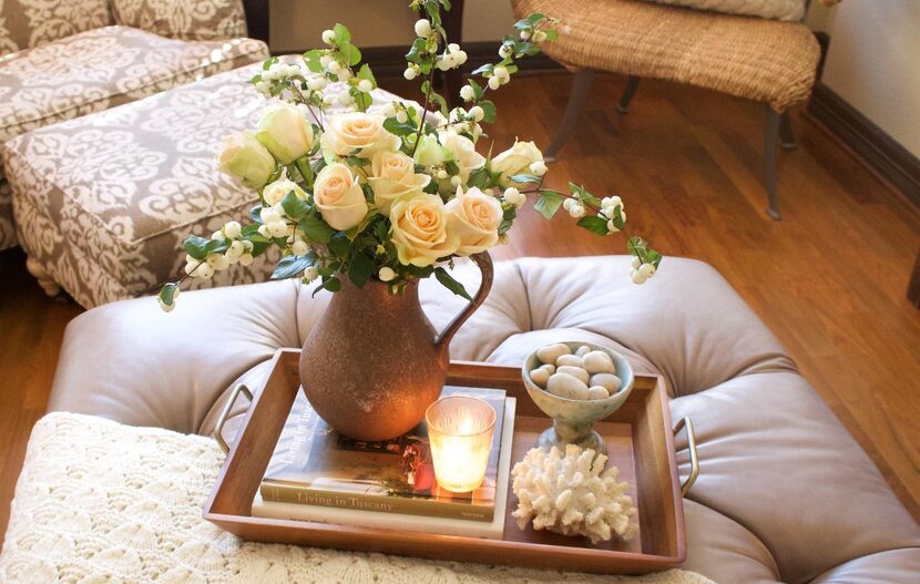 When styling  a tray, consider grouping a variety of elements, including candles and fresh...