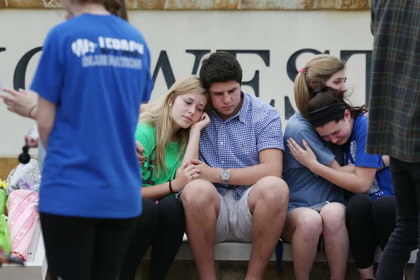Students at Plano West High School grieve after the slaying of junior Josiah Utu. His...