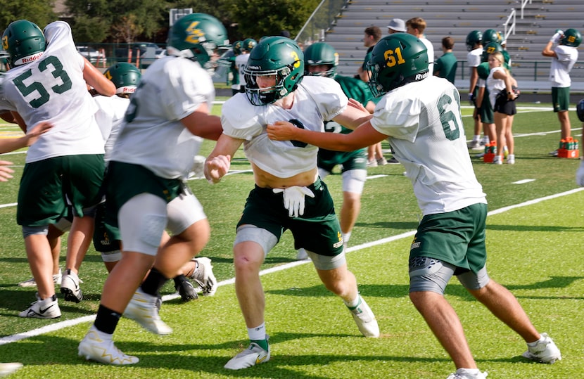 Frisco Legacy Christian Academy defensive end/tight end Tres Harris (3) pushed past...