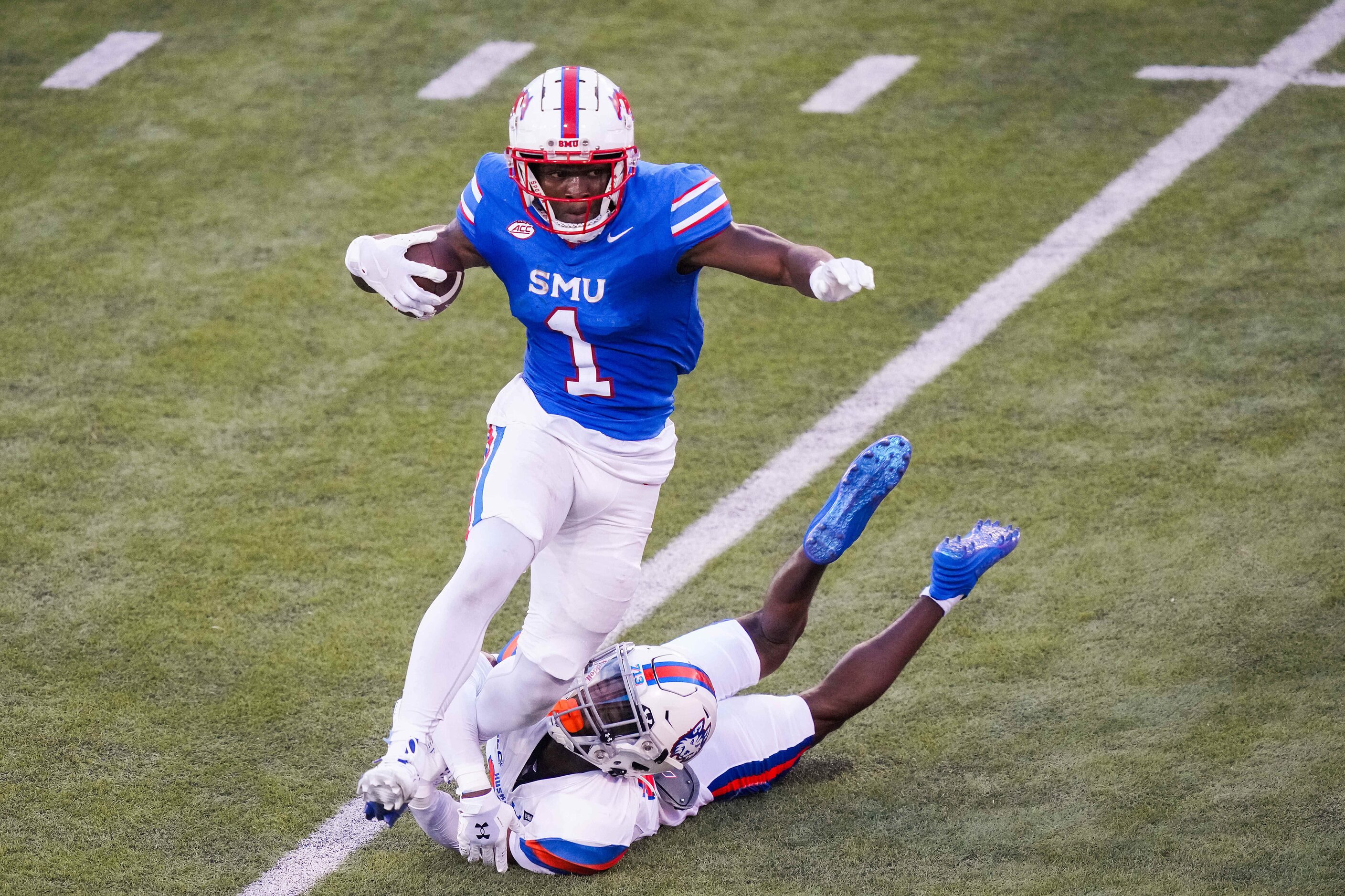 SMU running back Brashard Smith (1) gets past Houston Christian defensive back Will Johnson...