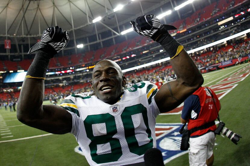 Donald Driver #80 of the Green Bay Packers celebrates as he walks off the field after the...