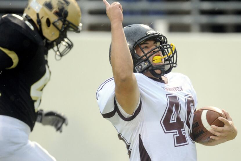 Mansfield Timberview's Daniel Ramos celebrates as he scores a touchdown in the final seconds...