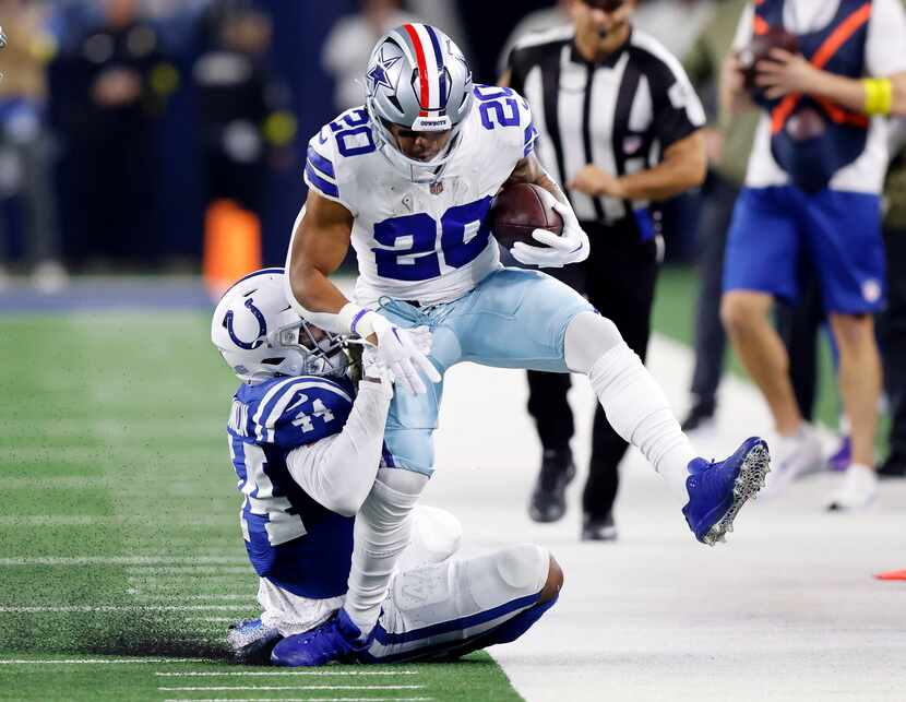 Dallas Cowboys running back Tony Pollard (20) is dragged out of bounds by Indianapolis Colts...