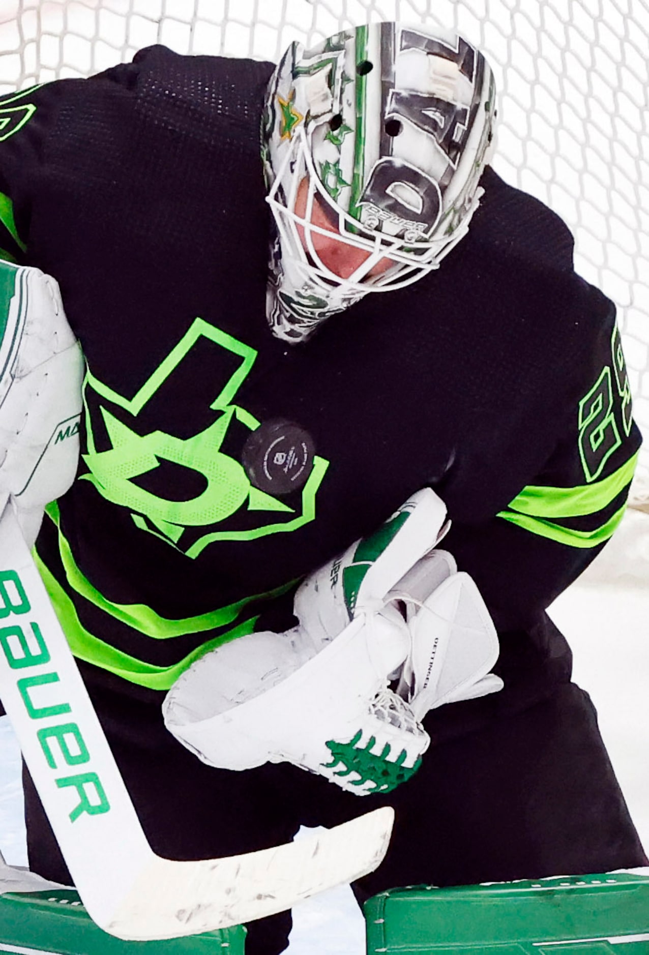 Dallas Stars goaltender Jake Oettinger (29) takes a shot to the face mask during the third...