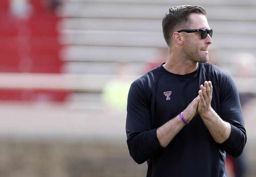 Texas Tech coach Kliff Kingsbury stands during a spring NCAA college football game Saturday,...