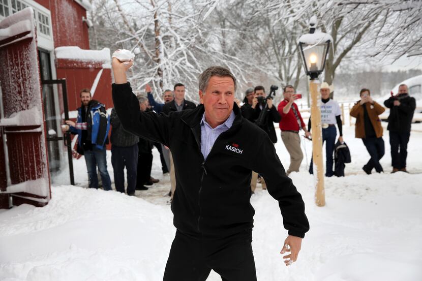 John Kasich, his staff and reporters threw snowballs Friday in Hollis, N.H., after Kasich’s...
