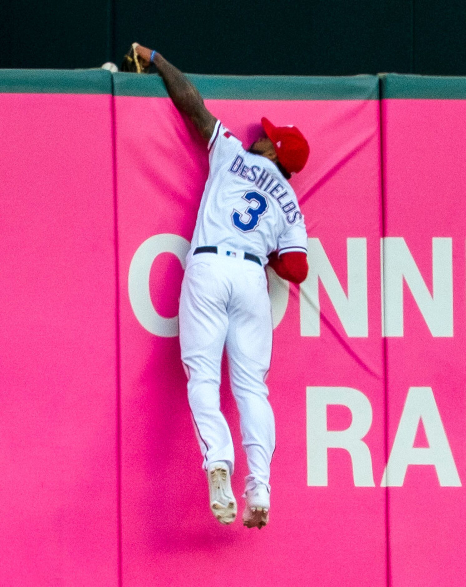 Texas Rangers center fielder Delino DeShields (3) canÃt make the play on a home run off the...