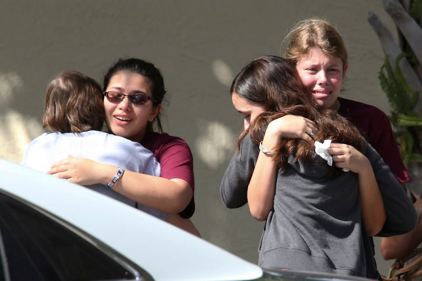 Students grieve outside Pines Trail Center where counselors were present after Wednesday's...