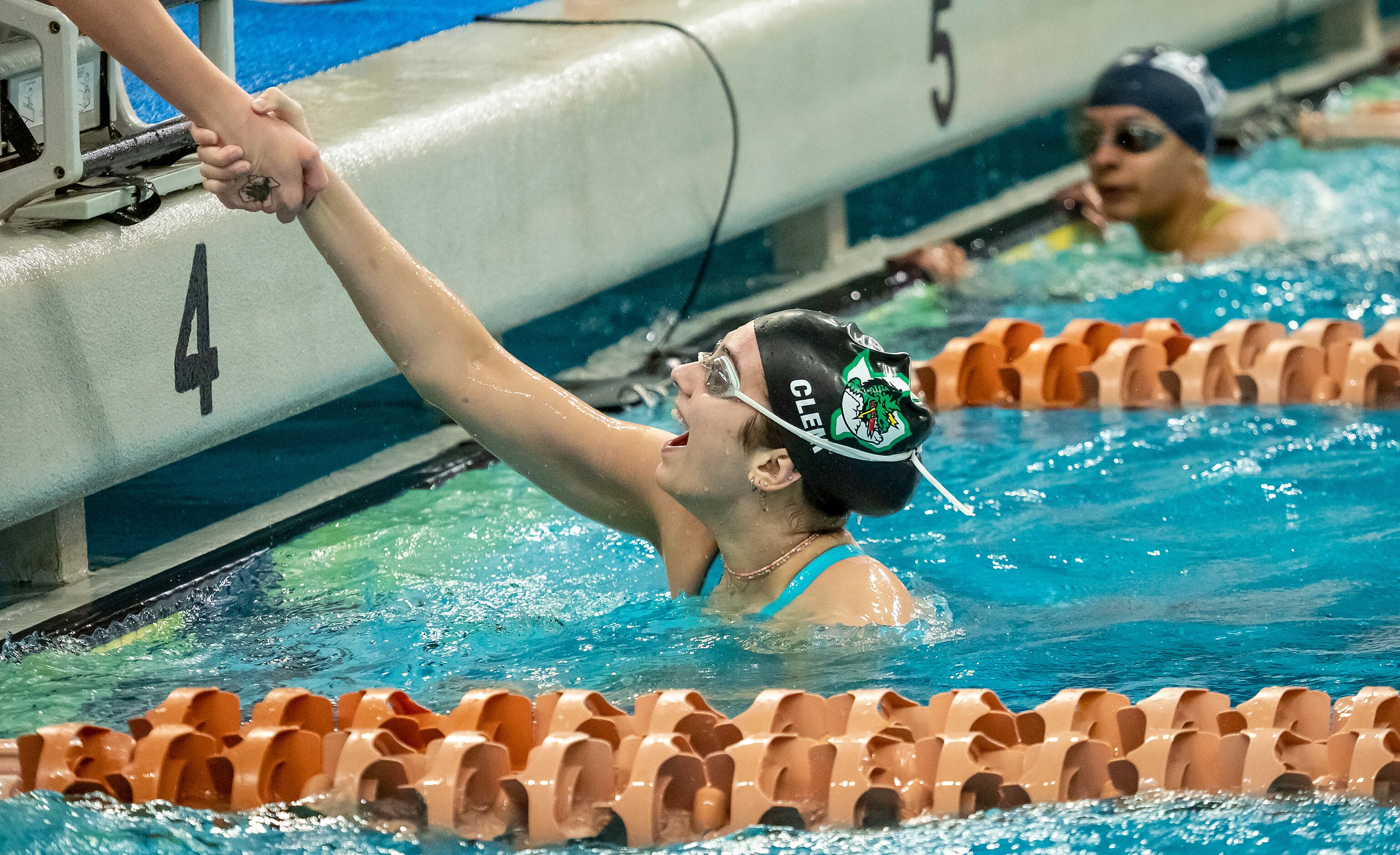 Southlake Carroll's Marin Clem is congratulated by a teammate after competing in the 200...