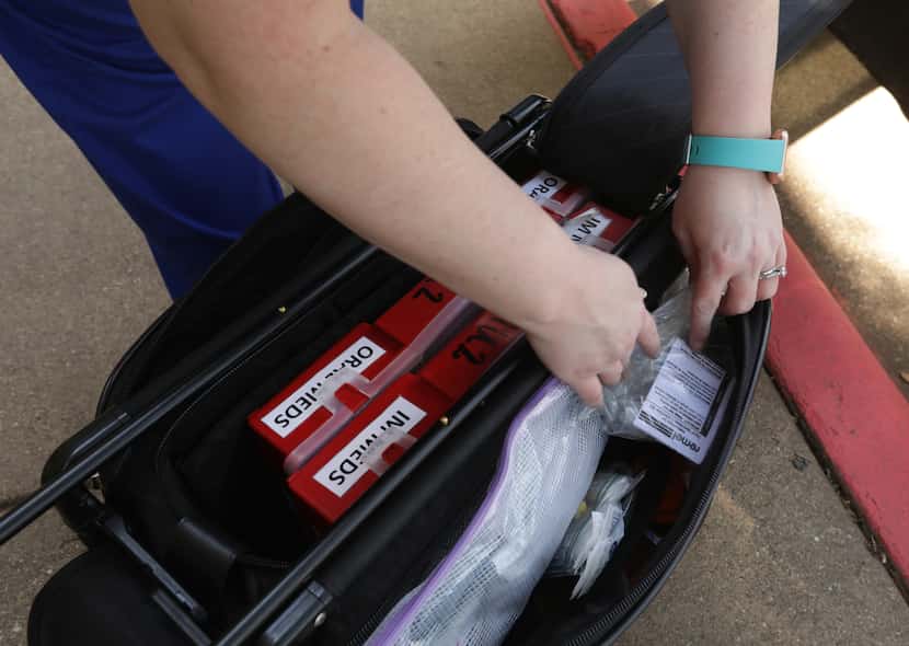 Charlee McHale checked a mobile COVID testing kit at UrgentCare2Go in Farmers Branch on May 19.