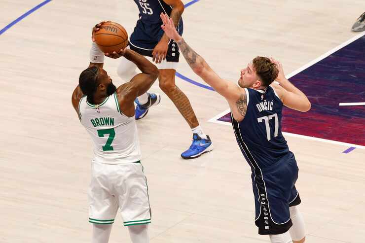 Dallas Mavericks guard Luka Doncic (77) contests a shot attempt from Boston Celtics guard...