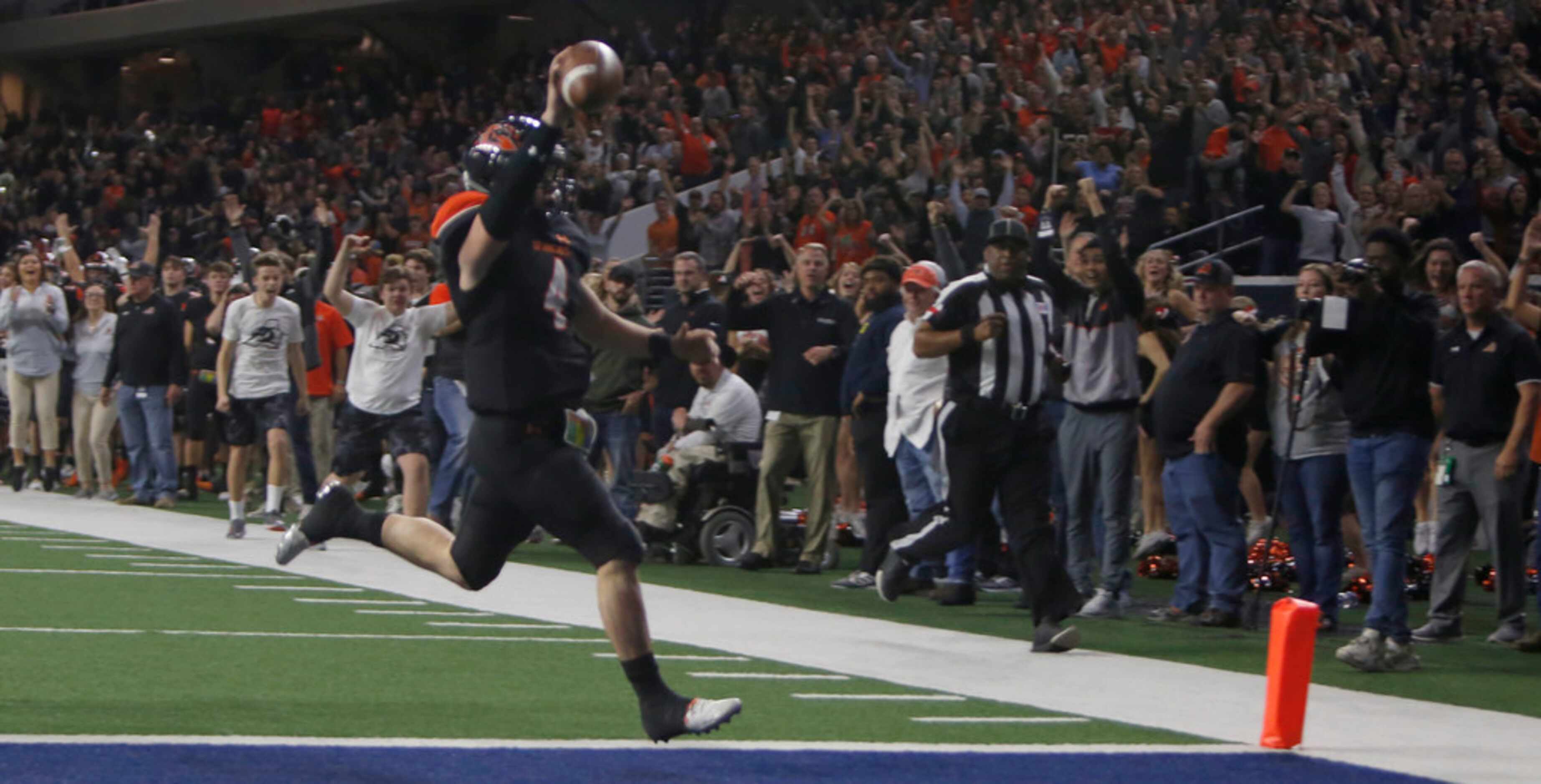 Aledo quarterback Jake Bishop (4) raises the ball over his head and ignites Bearcats fans as...
