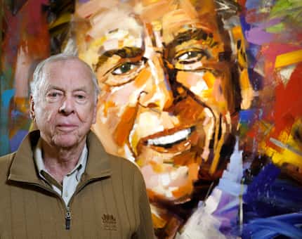 T. Boone Pickens, Chairman and CEO of BP Capital, poses in front of his portrait by Steve...