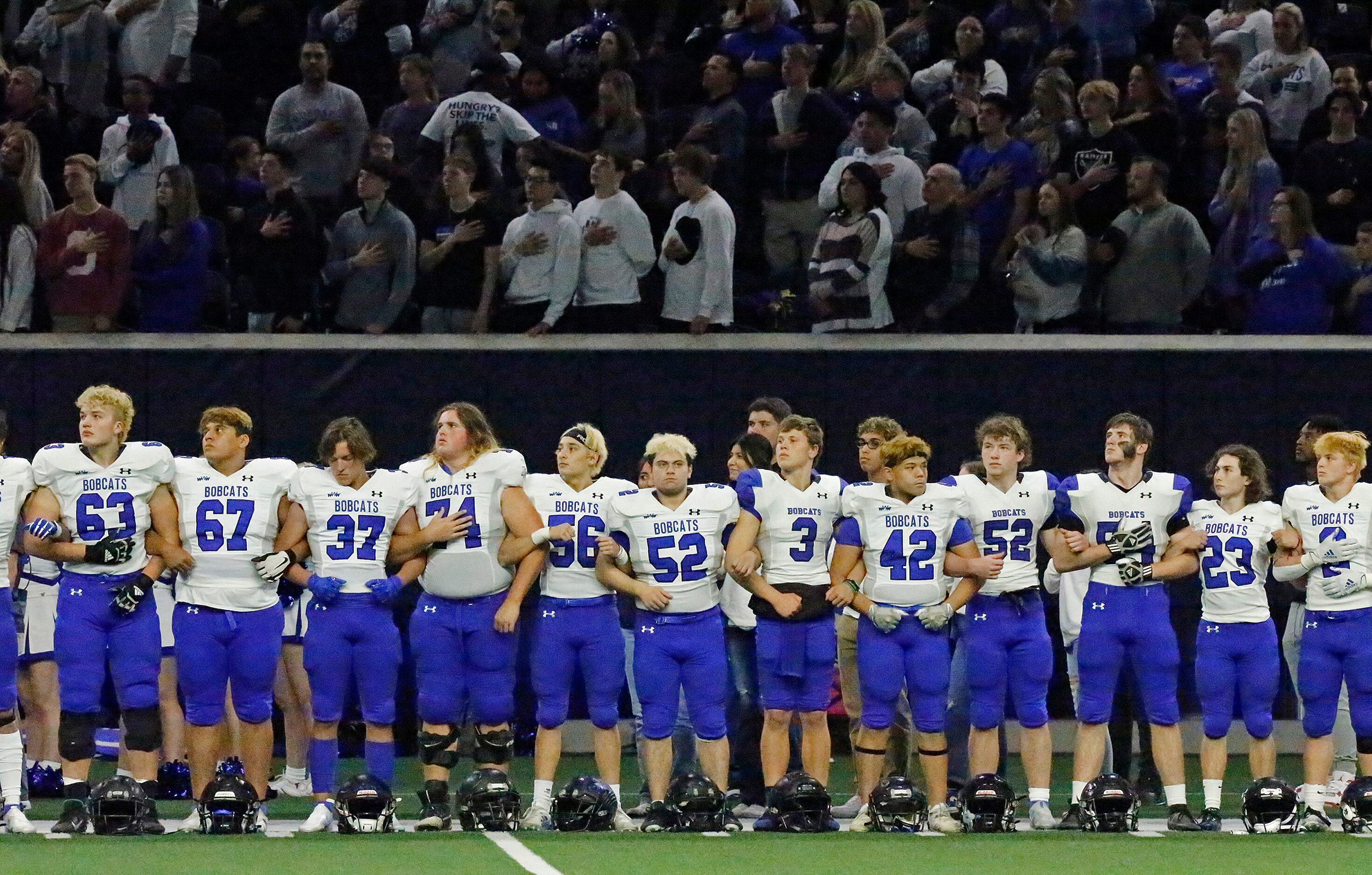 The Byron Nelson team links arms for the national anthem before kickoff  as Denton Guyer...