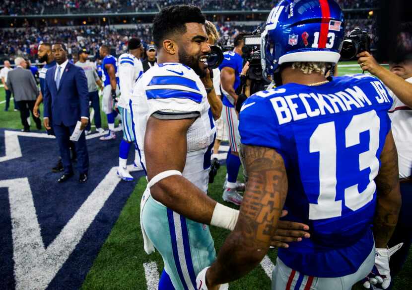 Dallas Cowboys running back Ezekiel Elliott (21) greets New York Giants wide receiver Odell...