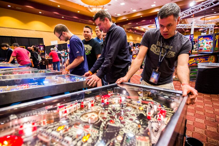Greg Banister, right, of Atlanta, Georgia gets in to a game during the 2015 Texas Pinball...