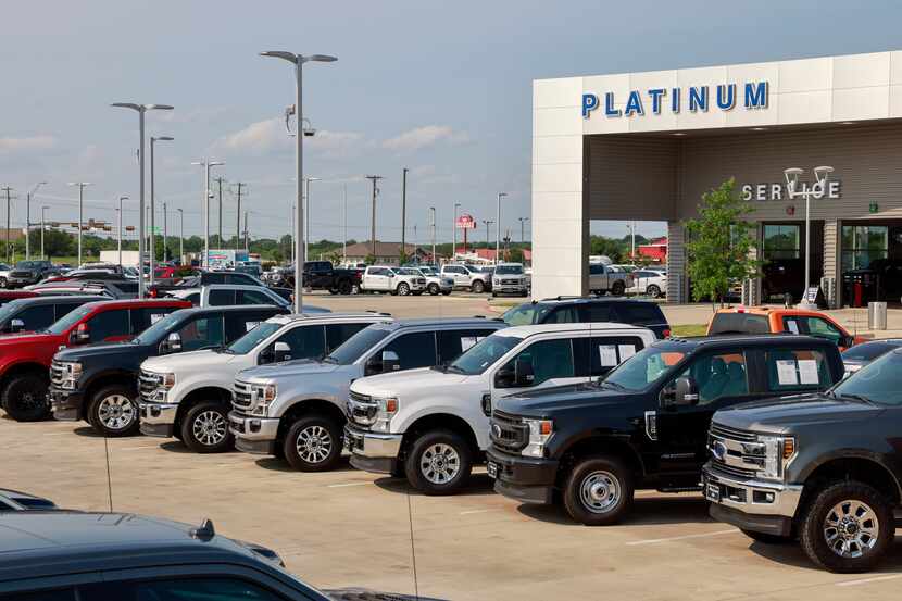 Ford pickup trucks sit outside at Platinum Ford in Terrell on May 16, 2022.