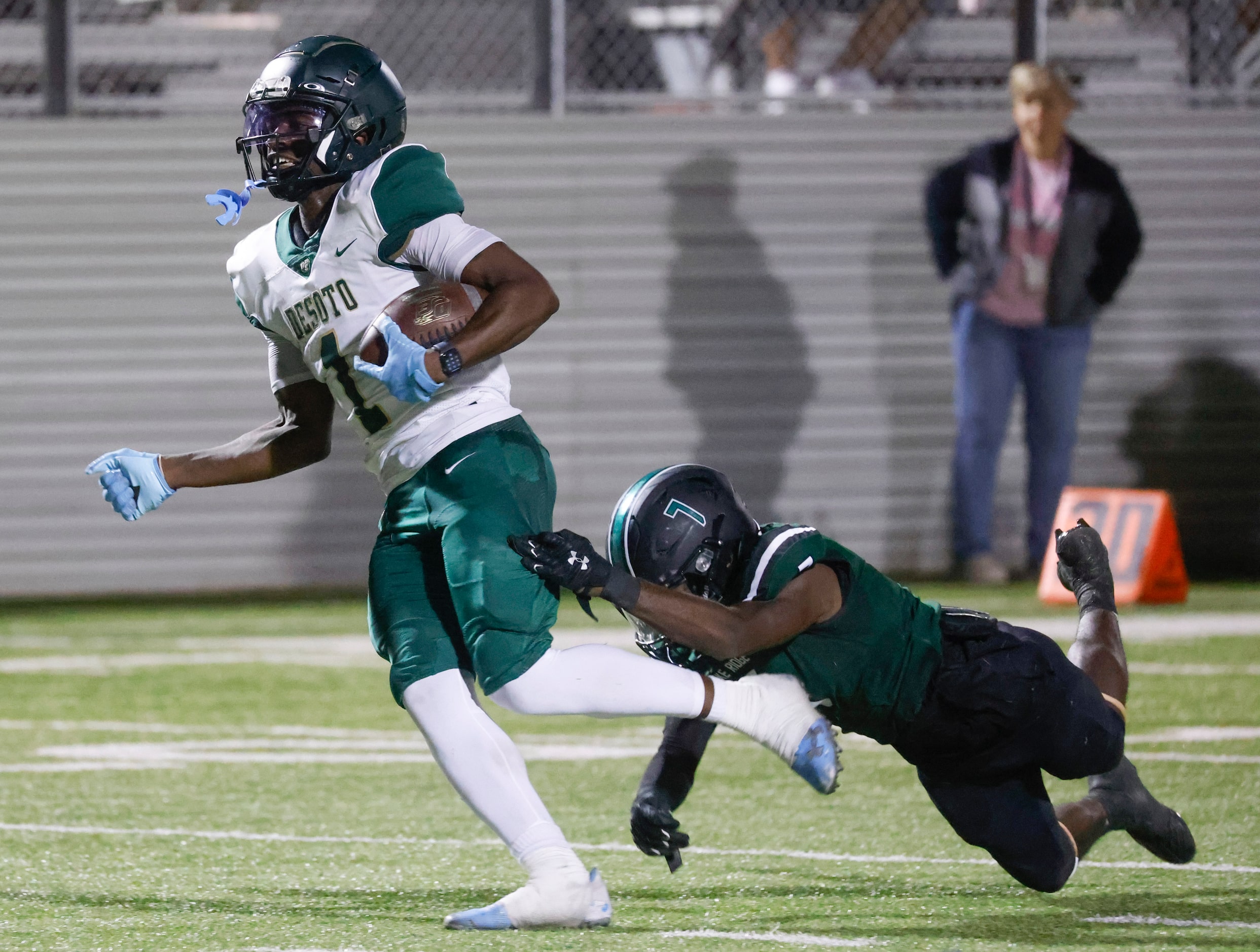 DeSoto High School’s Johntay Cook II (1), left, completes a touchdown against Lake Ridge...