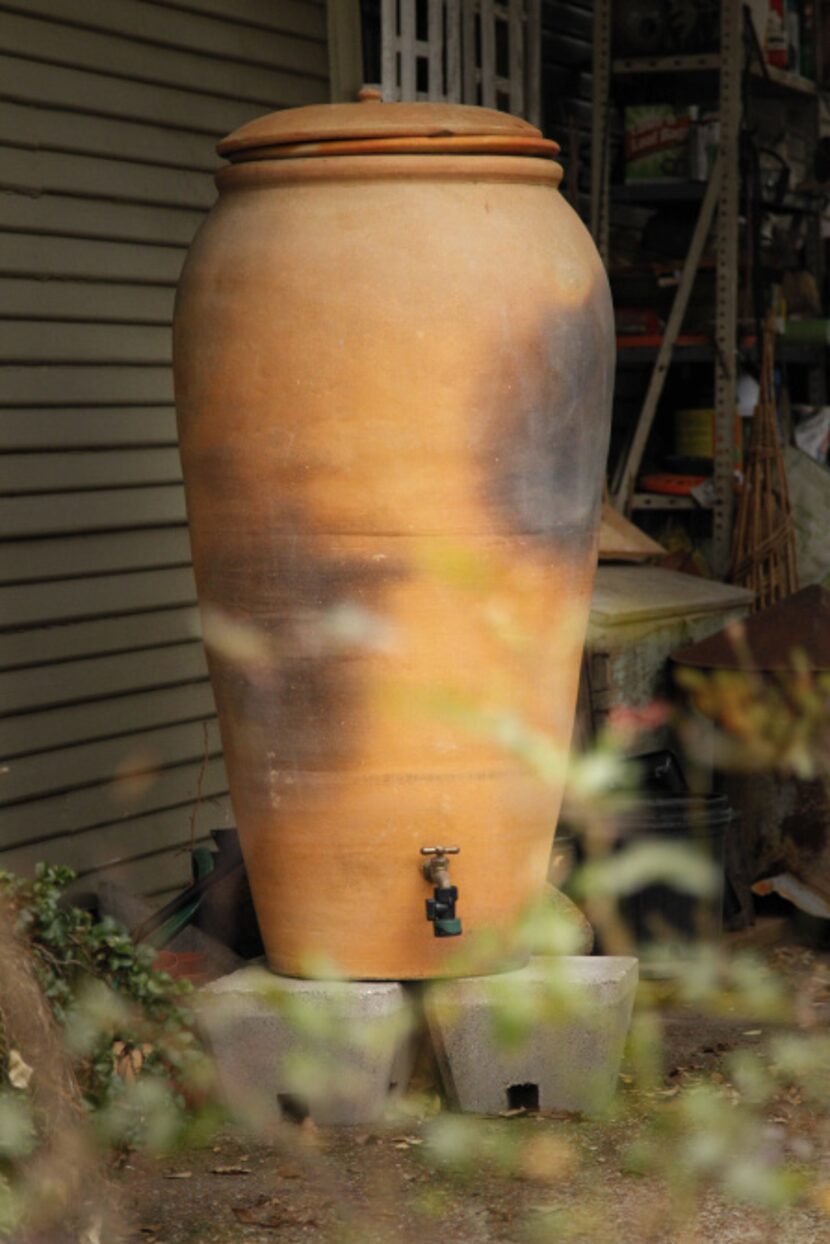 The terra-cotta rain barrel from Regalos de la Tierra in Oaxaca, Mexico at Mariana Greene's...