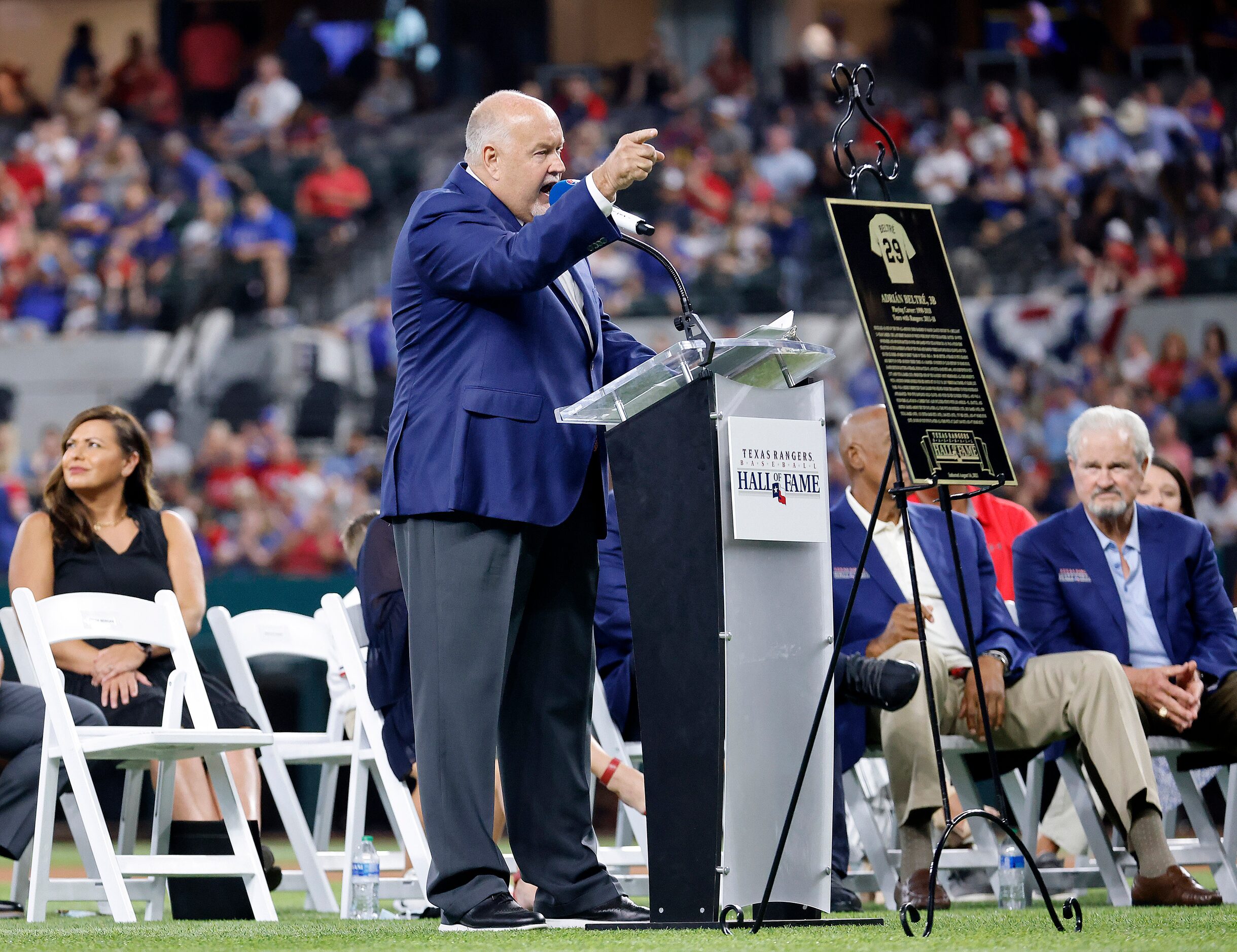 Texas Rangers executive vice president and public address announcer Chuck Morgan delivers...