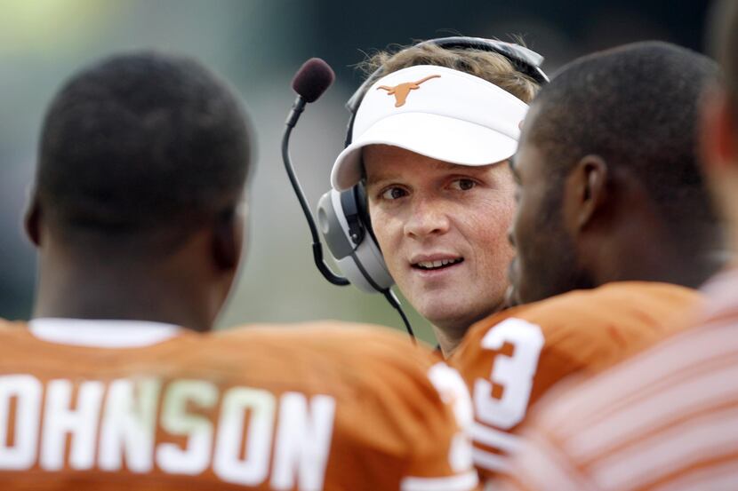 Texas' Major Applewhite talks to players on the sideline in a game against Arkansas during...
