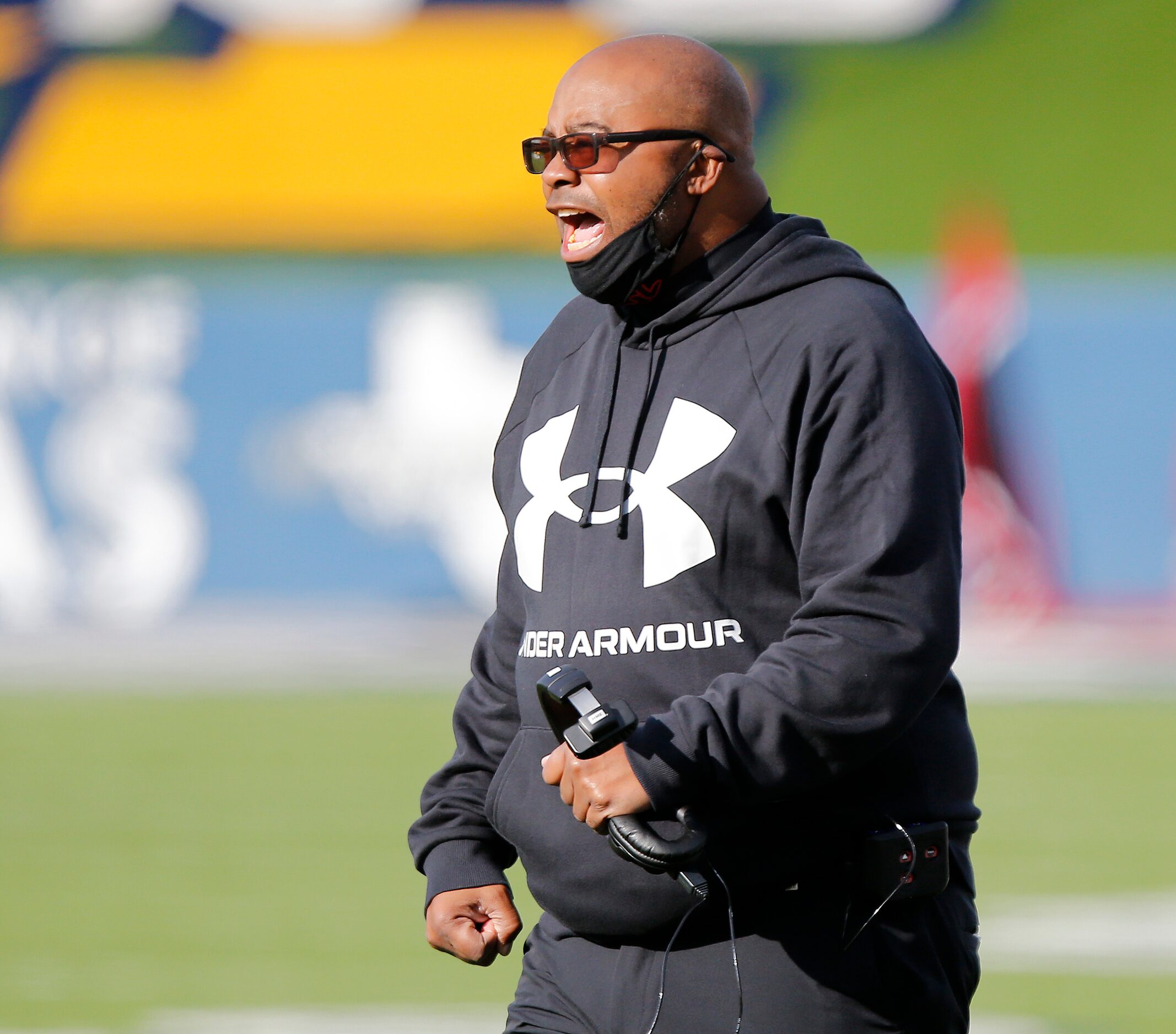 Cedar Hill High School head coach Carlos Lynn shouts to his team after a play during the...