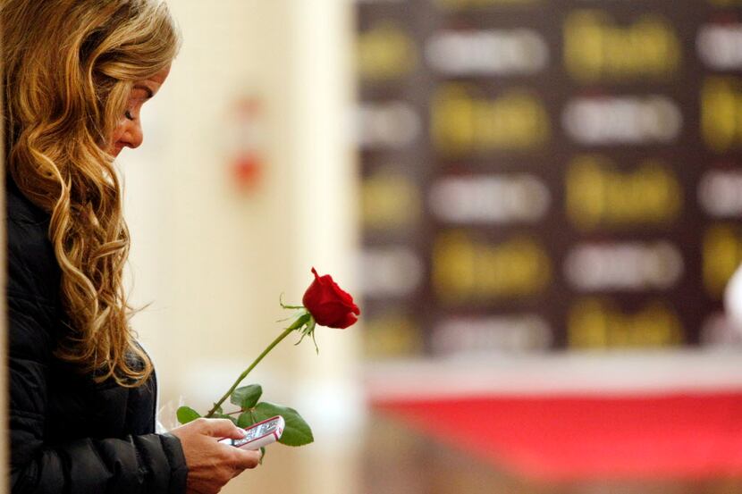 Barbara Tomasino of Plano holds onto a rose that she brought to give to The Bachelor Sean...