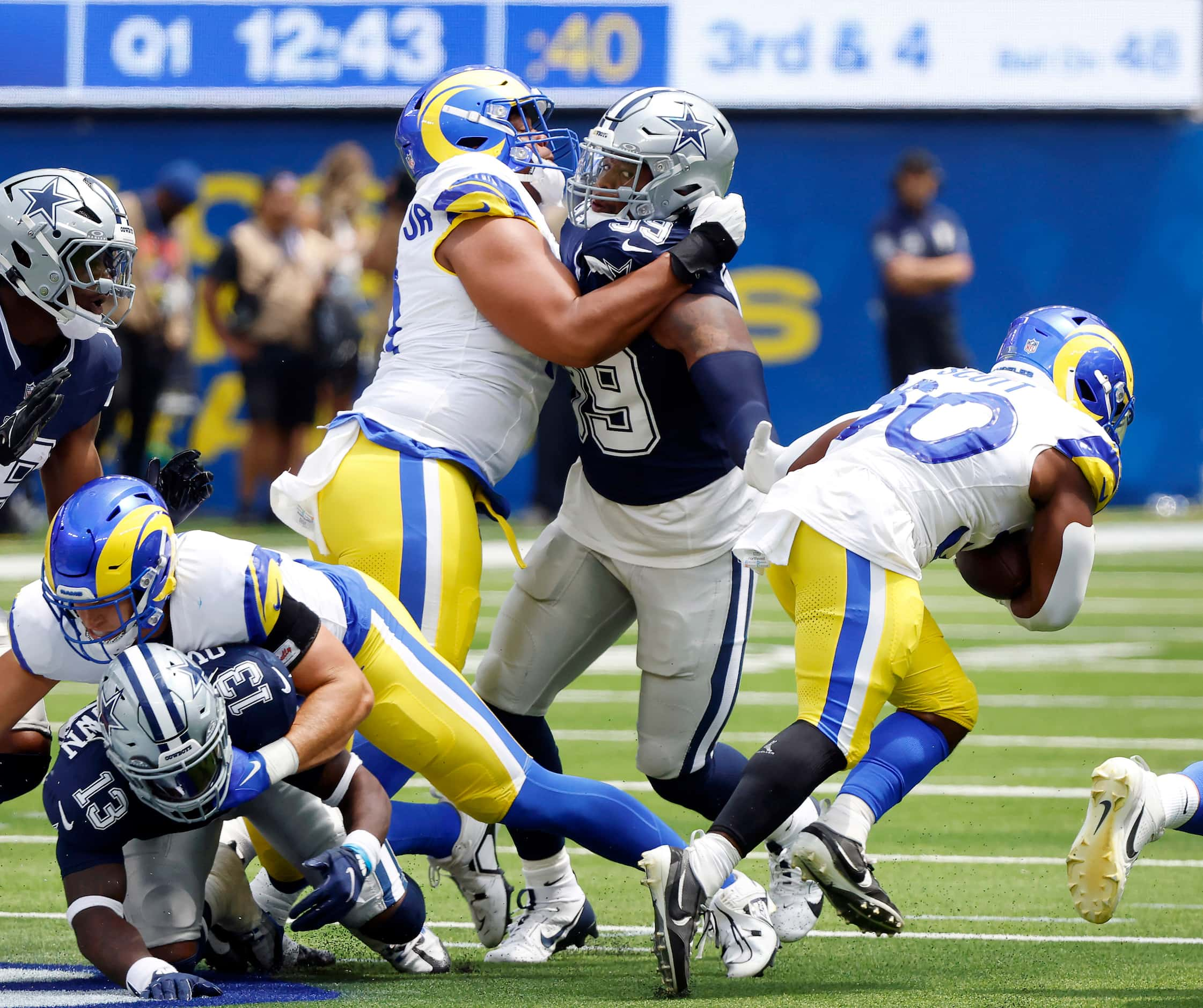 Dallas Cowboys defensive end Chauncey Golston (99) reaches out to Los Angeles Rams running...