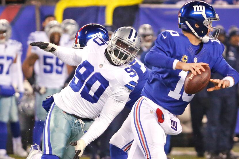 FILE - Dallas Cowboys defensive end Demarcus Lawrence (90) pressures New York Giants...