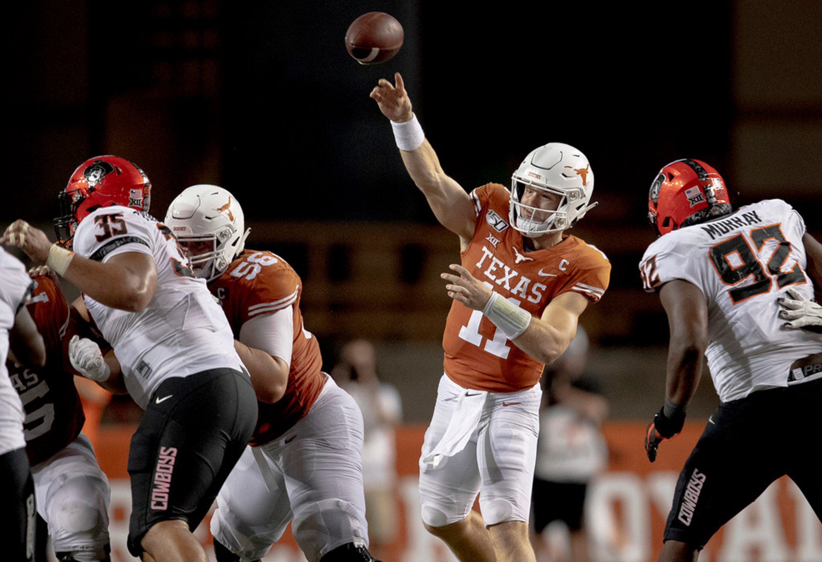 Texas quarterback Sam Ehlinger (11) throws the ball against Oklahoma State on Saturday,...