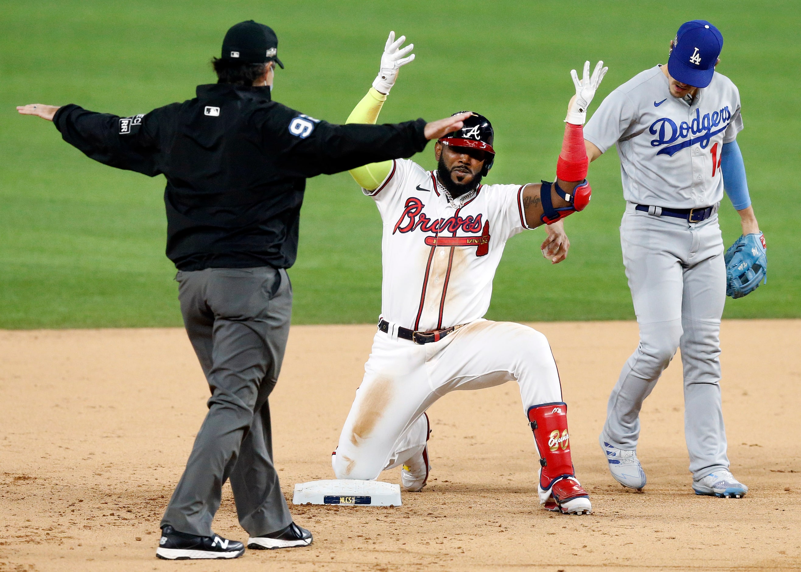 Atlanta Braves designated hitter Marcell Ozuna (20) celebrates his RBI double to deep center...